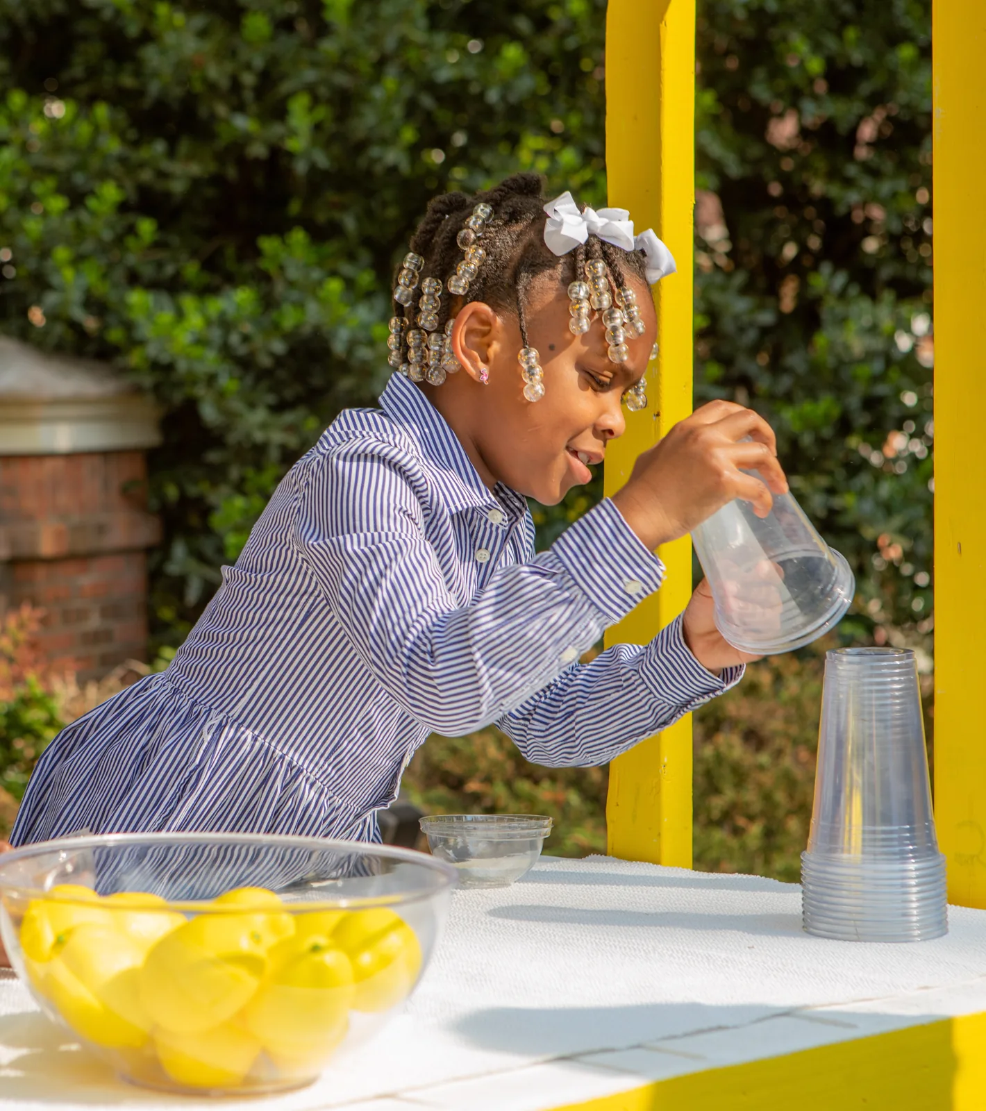 McKenzie setting up cups at the stand