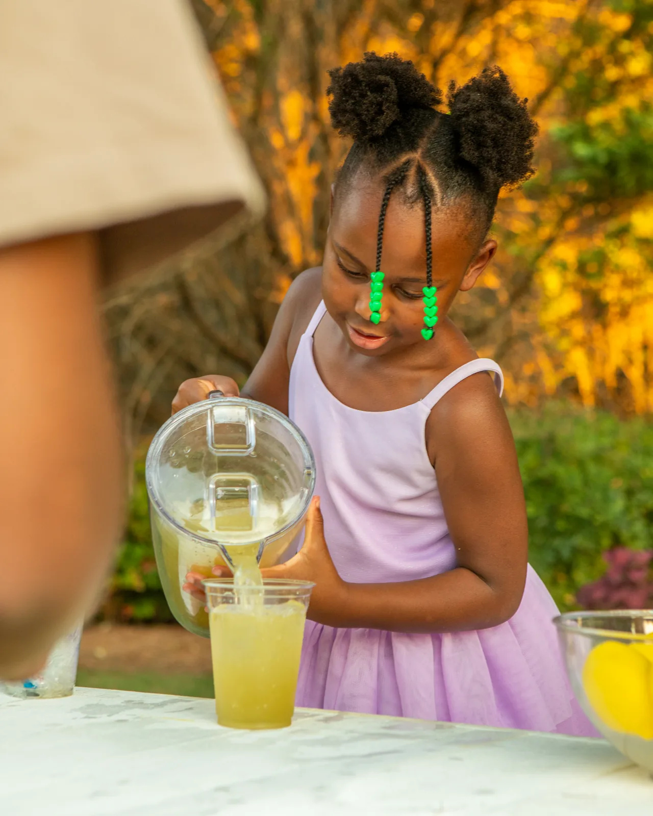 McKenzie pouring a fresh cup of lemonade