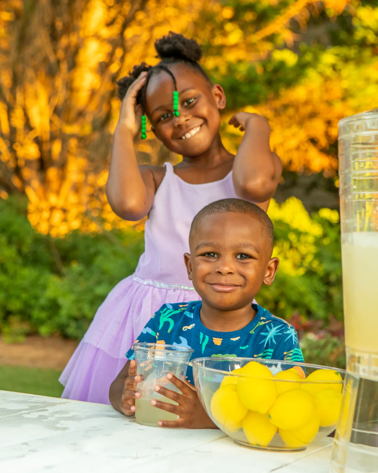 McKenzie and Jackson serving lemonade at golden hour
